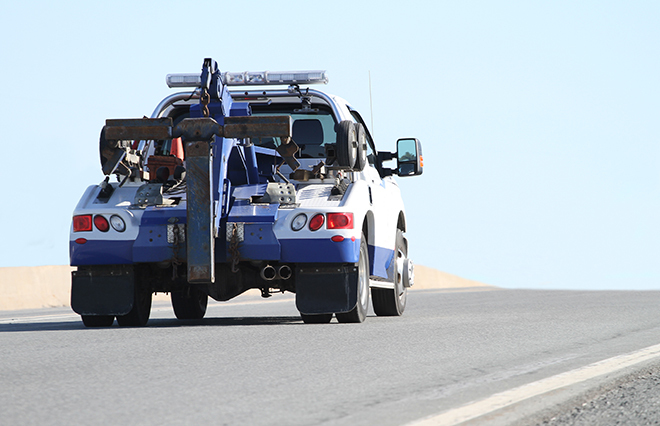 A tow truck driving along the road.